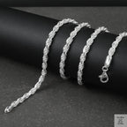 Silver rope chain on a black surface