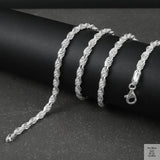 Silver rope chain on a black surface