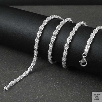 Silver rope chain on a black surface