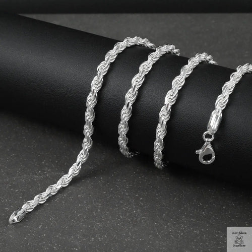 Silver rope chain on a black surface
