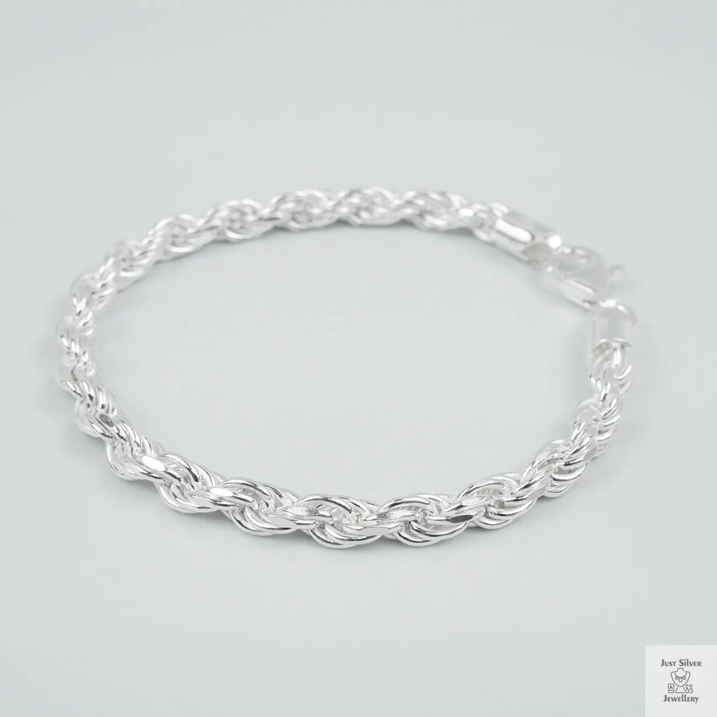 Silver rope bracelet on a light grey background