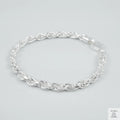Silver rope bracelet on a light grey background