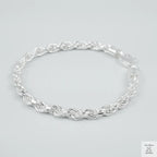 Silver rope bracelet on a light grey background
