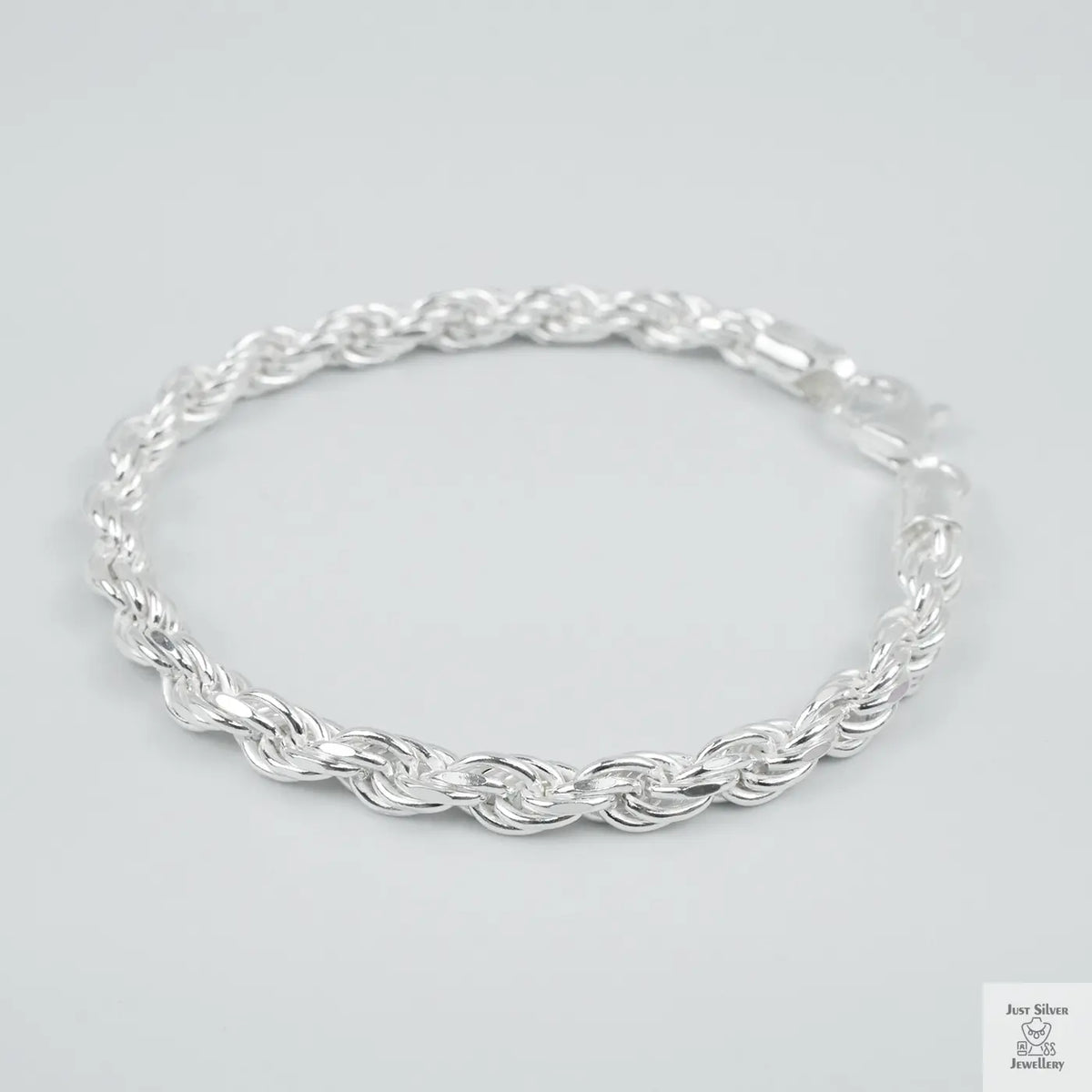 Silver rope bracelet on a light grey background