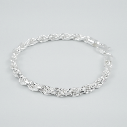 Silver rope bracelet on a light grey background