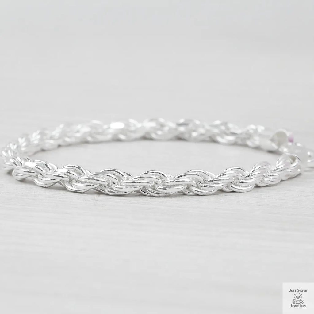 Silver rope bracelet on a light grey background