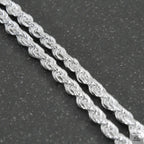 Silver chain on a light gray background