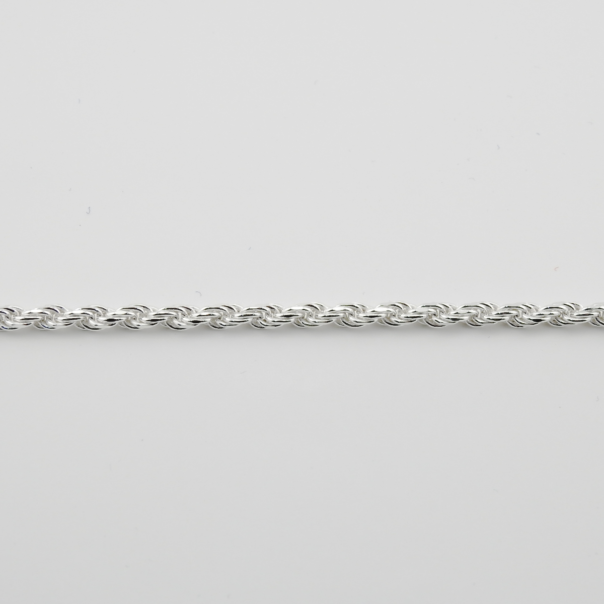 Silver chain on a light gray background
