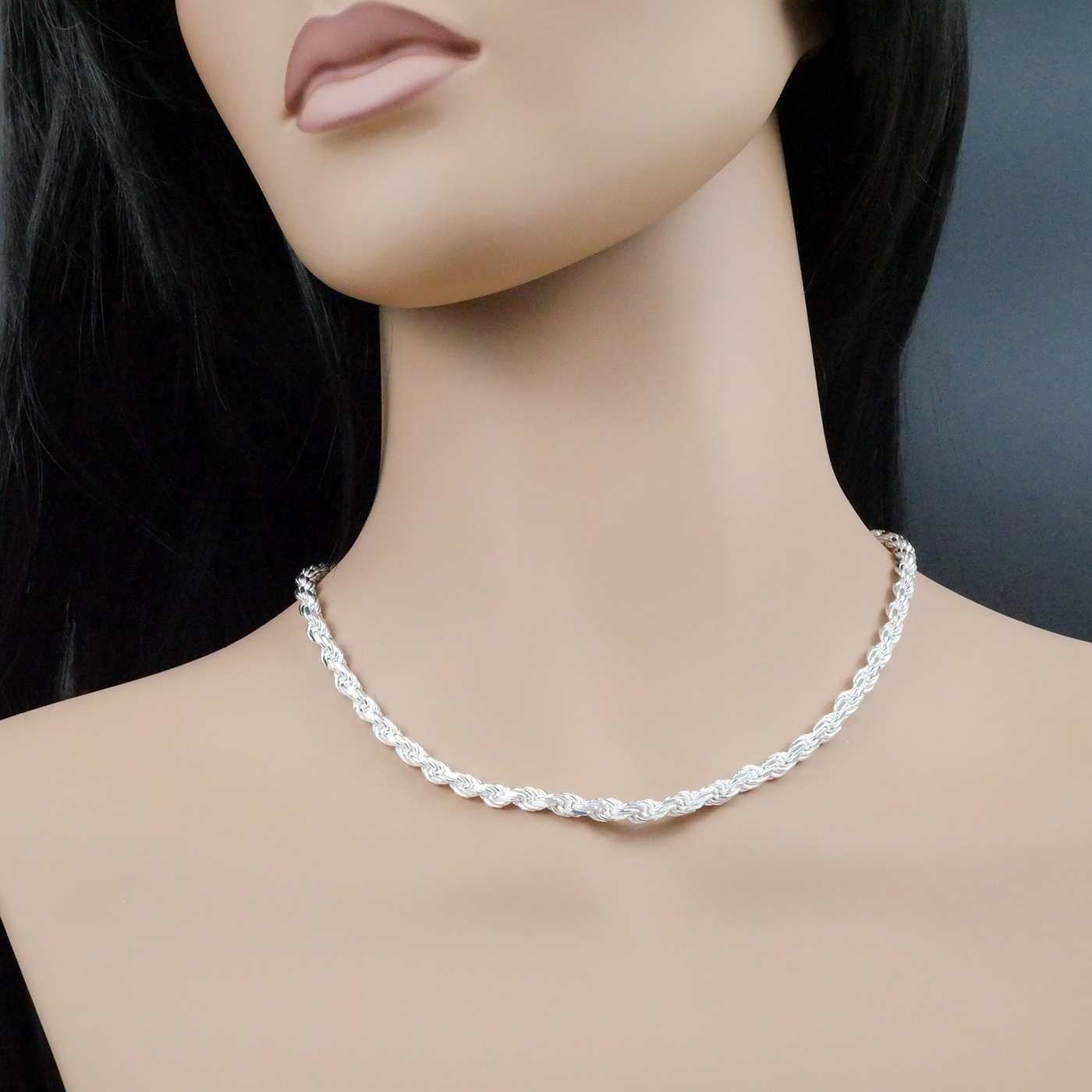 Silver necklace on a mannequin with a plain background