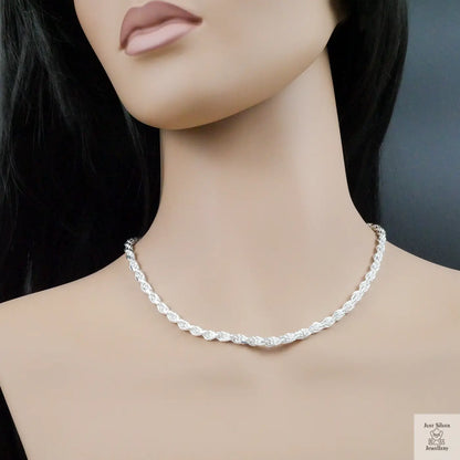 Silver necklace on a mannequin with a plain background