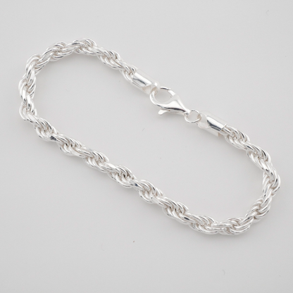 Silver chain bracelet on a light gray background