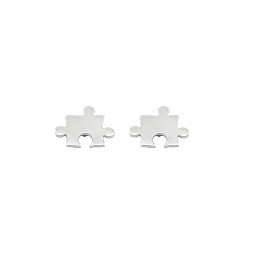 Two silver puzzle piece earrings on a white background