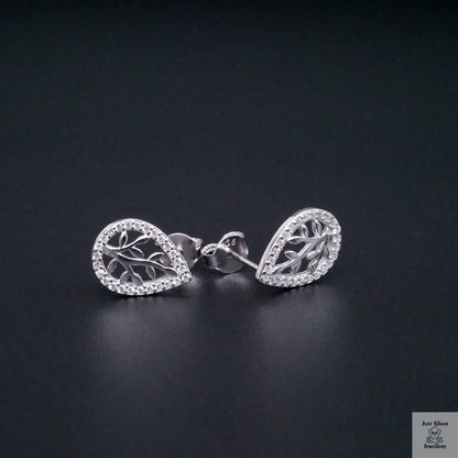 Silver leaf-shaped earrings on a black background