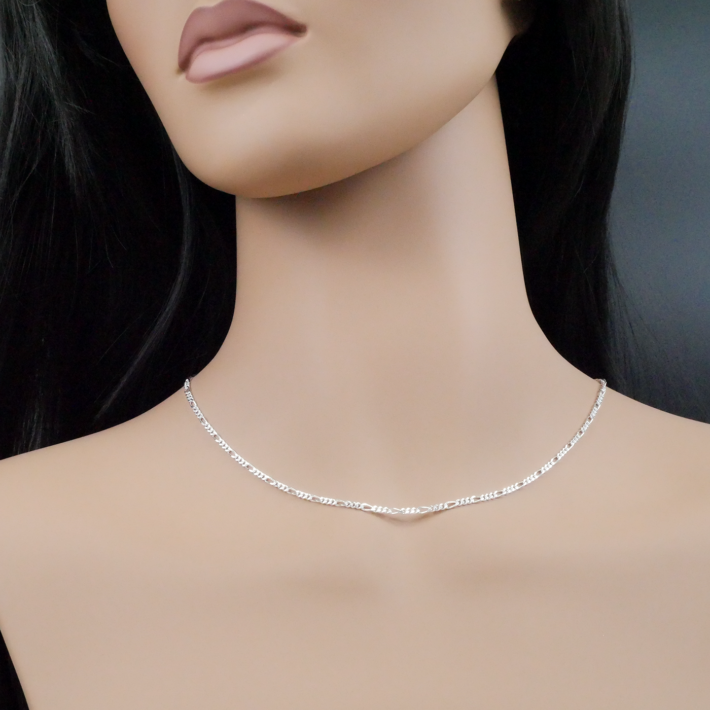 Mannequin wearing a silver necklace against a neutral background
