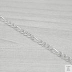 Silver chain on a light grey background