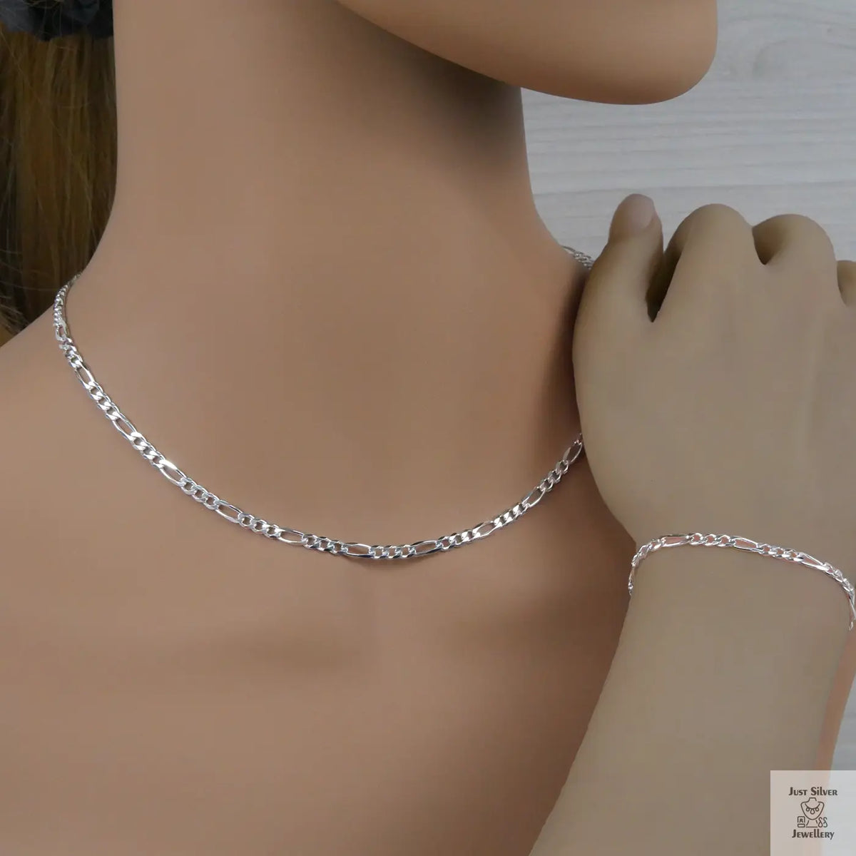 Silver figaro necklace and bracelet on a mannequin