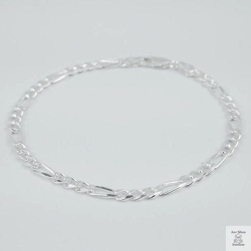 Silver bracelet on a light grey background