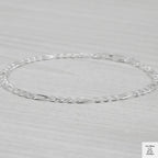 Silver bracelet on a light grey background