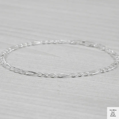 Silver bracelet on a light grey background