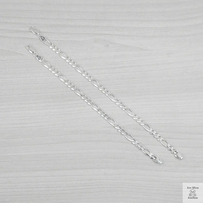 Silver bracelets on a textured grey background