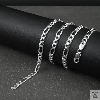 Silver figaro chain on a dark surface