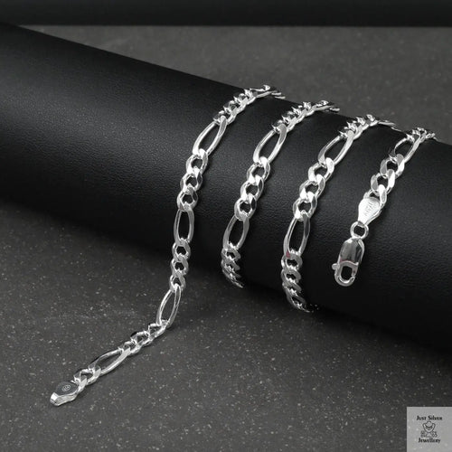 Silver figaro chain on a dark surface