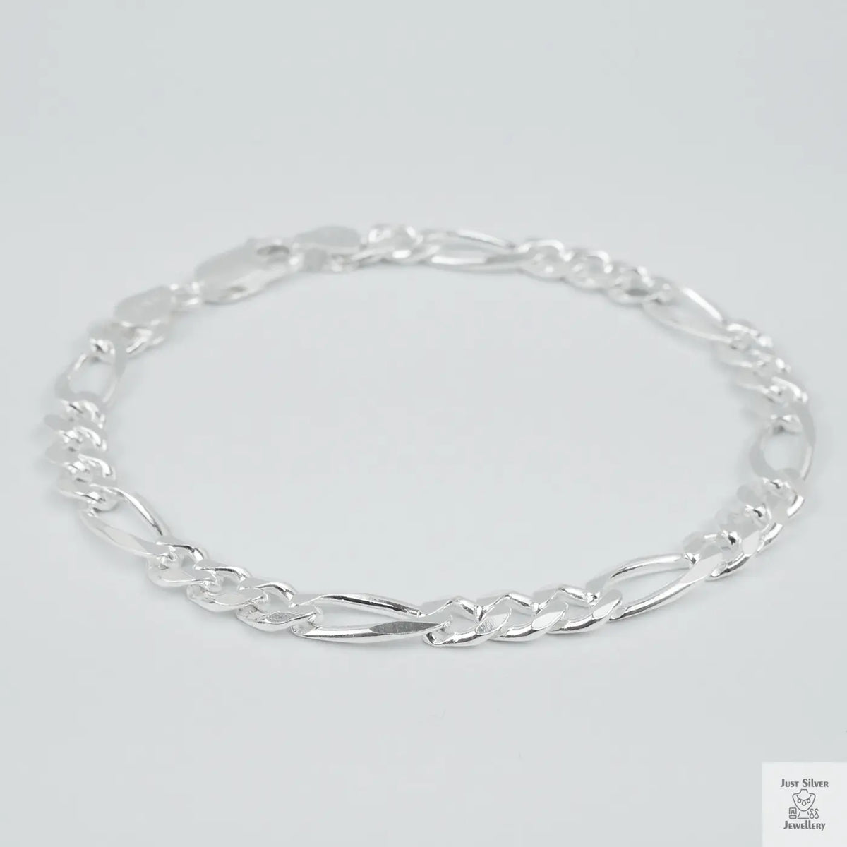 Silver bracelet on a light grey background