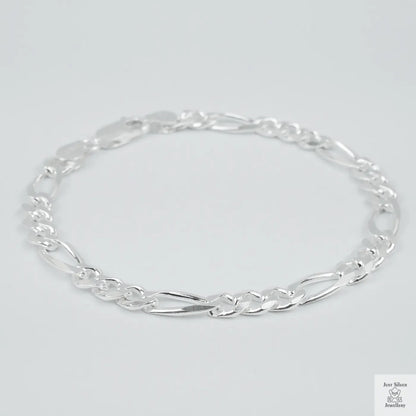 Silver bracelet on a light grey background
