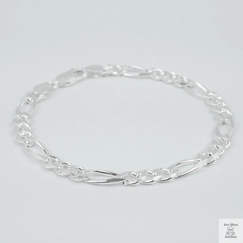 Silver bracelet on a light grey background