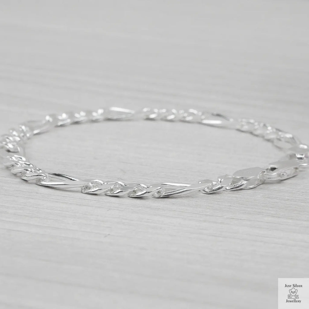 Silver bracelet on a light grey background