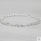 Silver bracelet on a light grey background