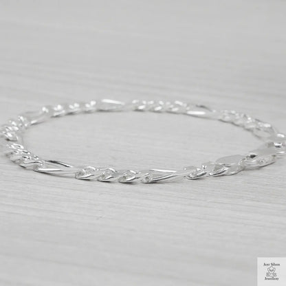 Silver bracelet on a light grey background