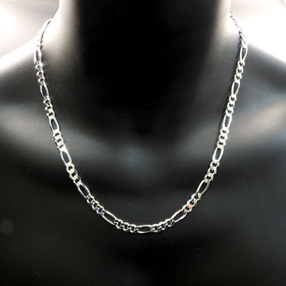 Silver chain necklace on a black mannequin bust.