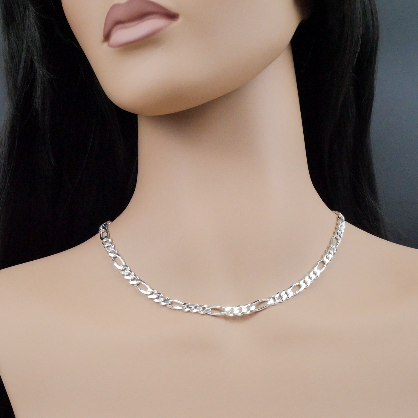 Silver chain necklace on a mannequin with a plain background