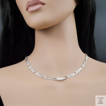 Silver chain necklace on a mannequin with a plain background