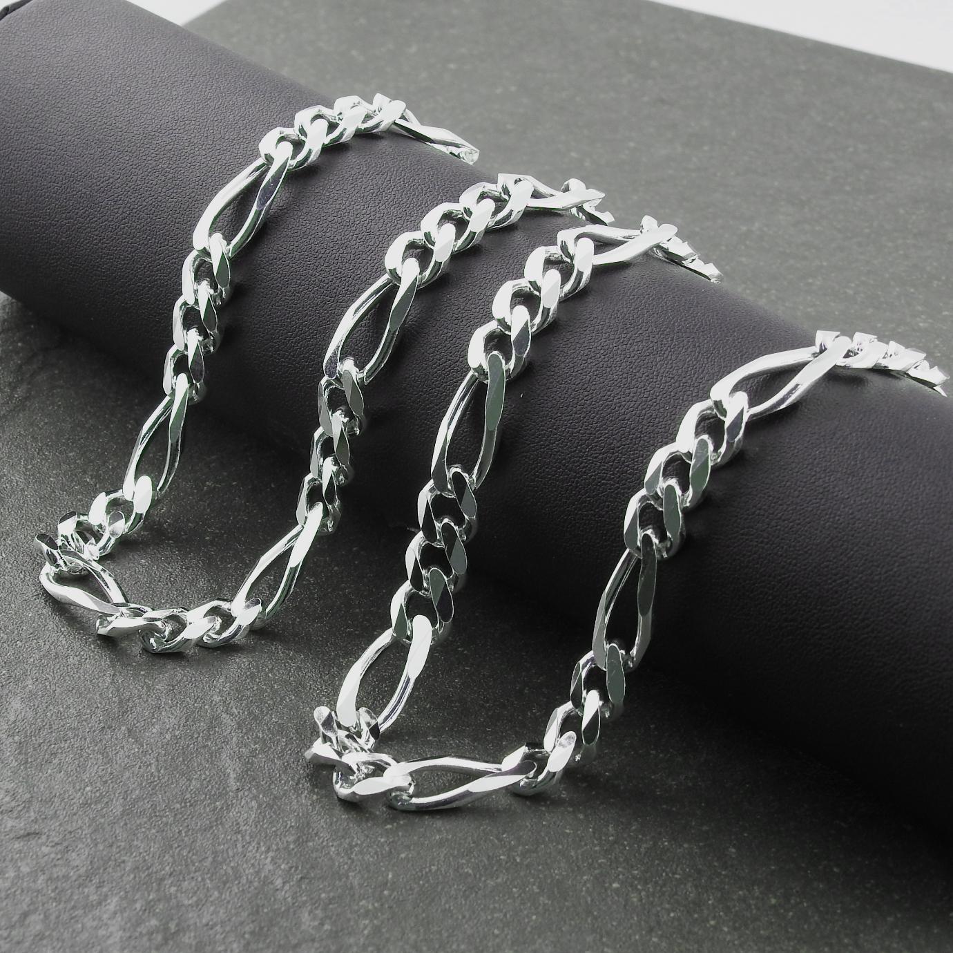 Silver chain bracelet on a dark surface