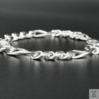 Silver bracelet on a dark surface