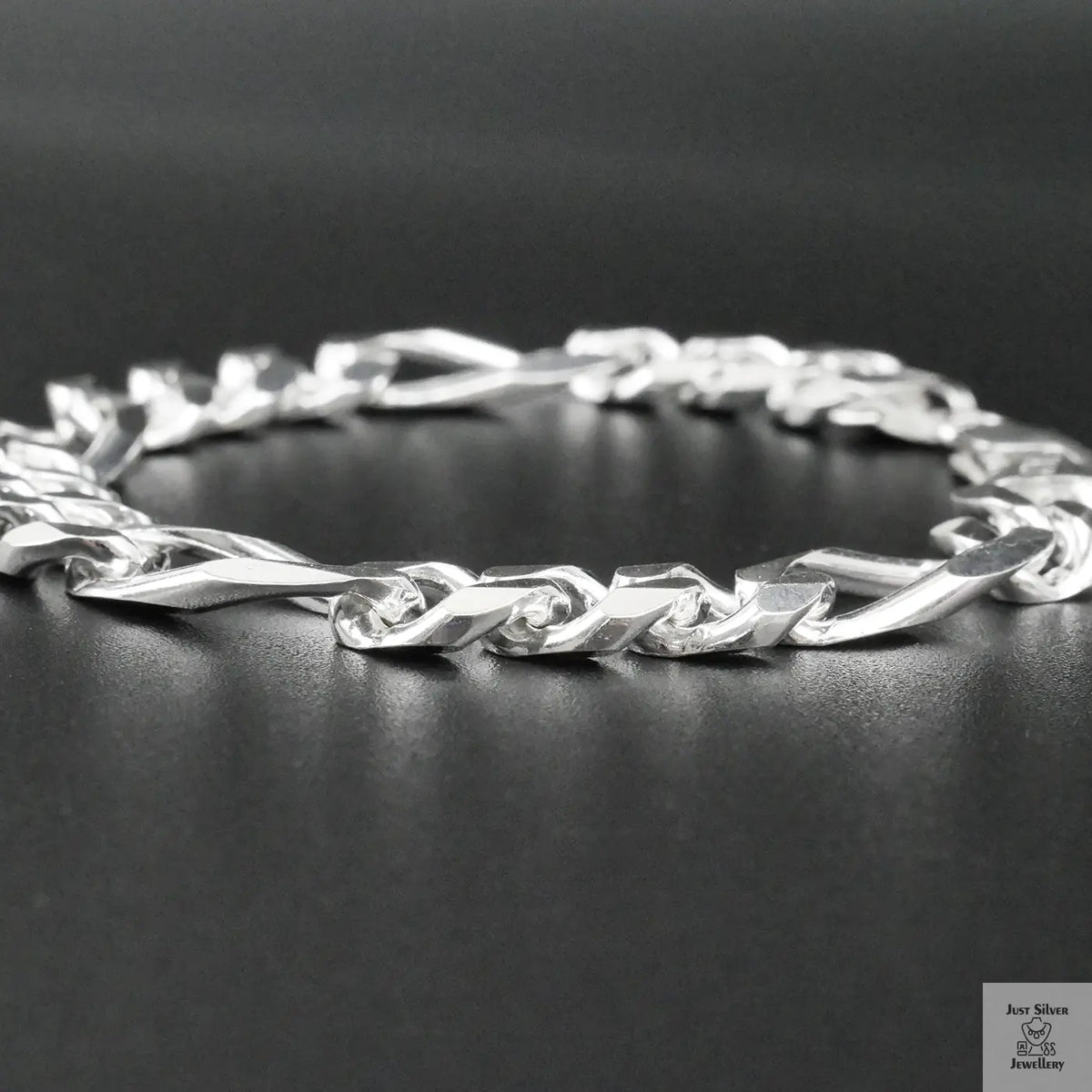 Silver bracelet on a dark surface