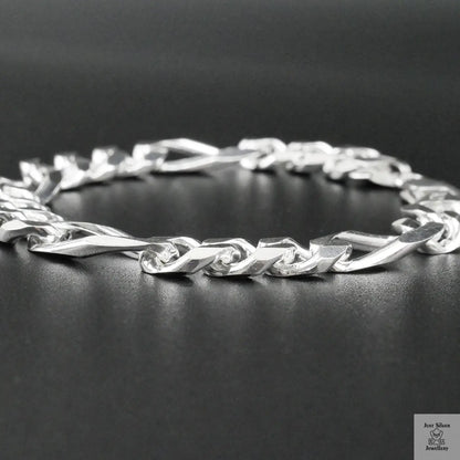 Silver bracelet on a dark surface