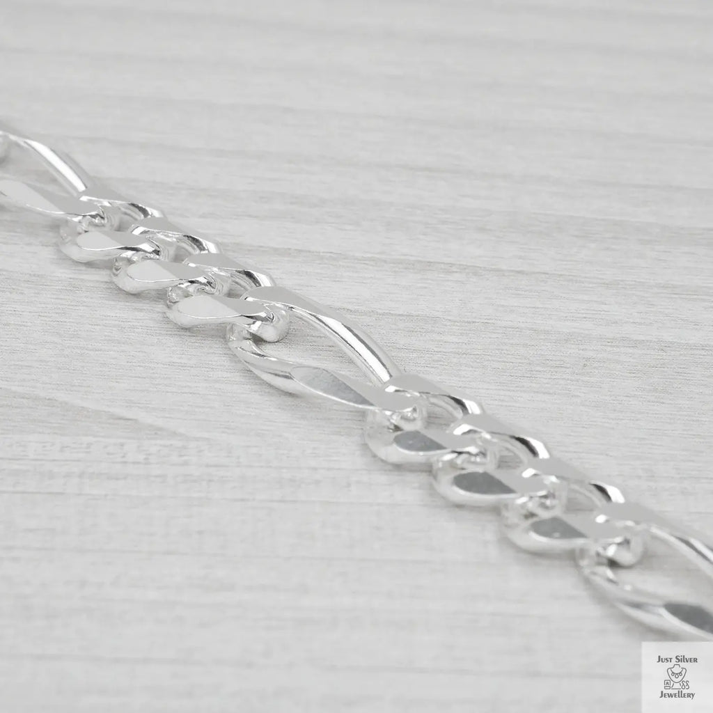 Silver bracelet on a light grey background