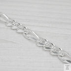 Silver bracelet on a light grey background