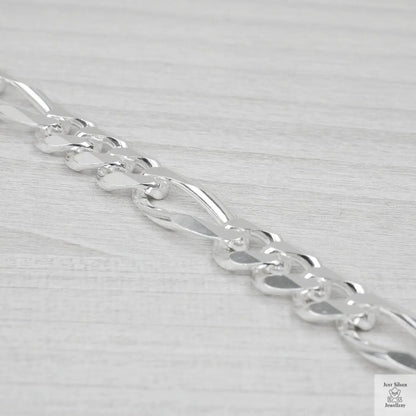 Silver bracelet on a light grey background