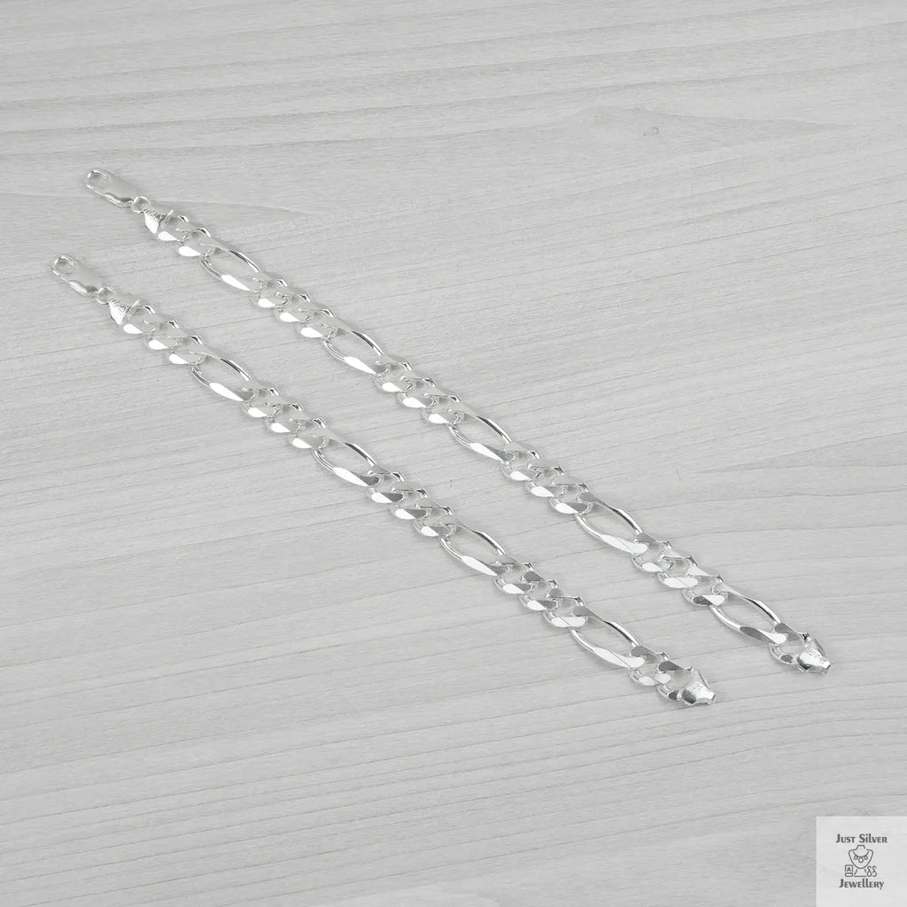 Silver bracelets on a light grey background