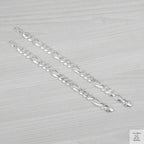 Silver bracelets on a light grey background