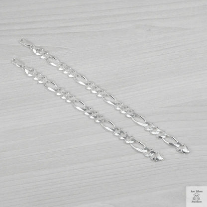 Silver bracelets on a light grey background
