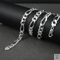 Silver figaro chain on a dark surface