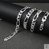 Silver figaro chain on a dark surface
