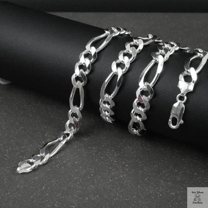 Silver figaro chain on a dark surface