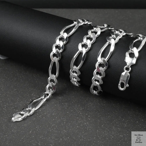 Silver figaro chain on a dark surface