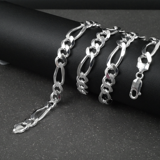 Silver figaro chain on a dark surface